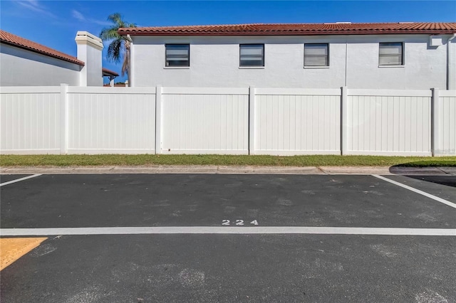 uncovered parking lot featuring fence