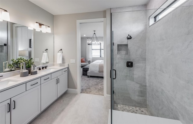 full bath featuring a tile shower, double vanity, a sink, and connected bathroom