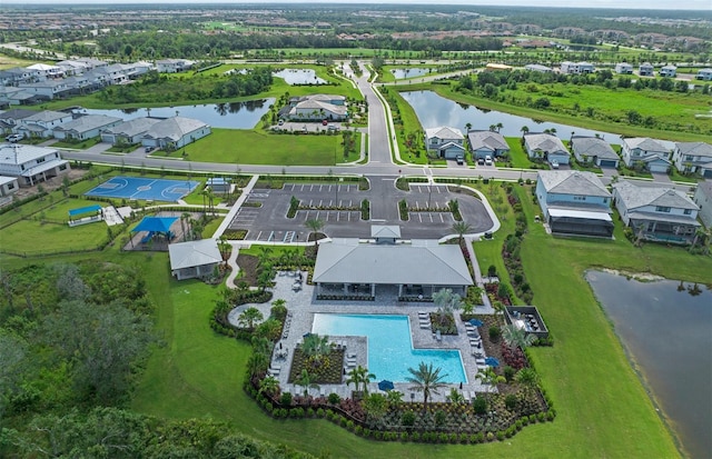 birds eye view of property with a water view and a residential view