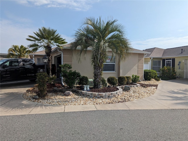 view of property exterior featuring stucco siding, an attached garage, and driveway