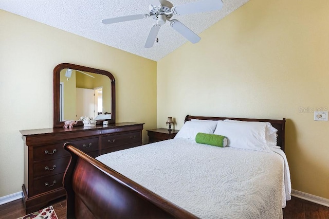 bedroom featuring dark wood-style floors, baseboards, lofted ceiling, ceiling fan, and a textured ceiling