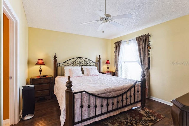 bedroom featuring baseboards, a textured ceiling, wood finished floors, and a ceiling fan