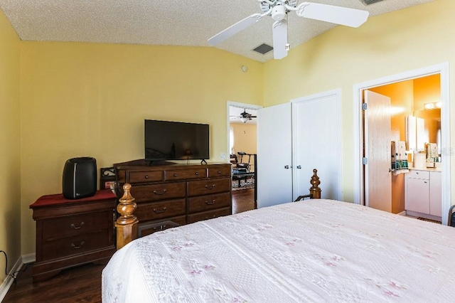 bedroom featuring visible vents, dark wood-type flooring, lofted ceiling, a textured ceiling, and a ceiling fan