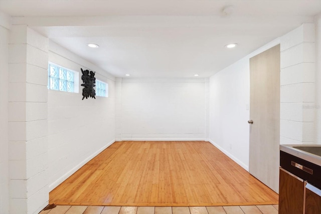 below grade area featuring recessed lighting, baseboards, and light wood finished floors