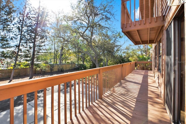 wooden terrace featuring fence