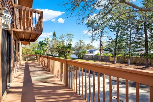 wooden terrace featuring fence