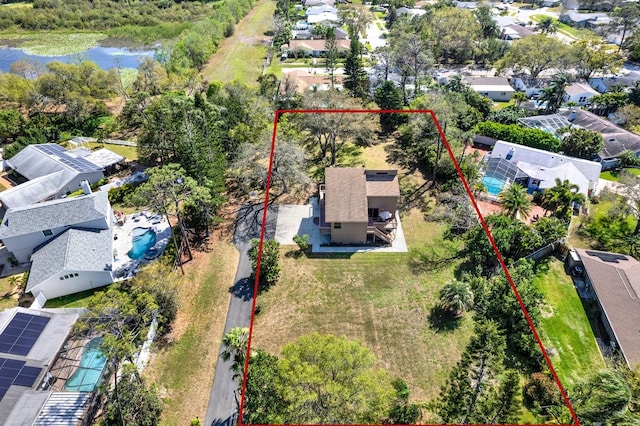 drone / aerial view featuring a residential view and a water view