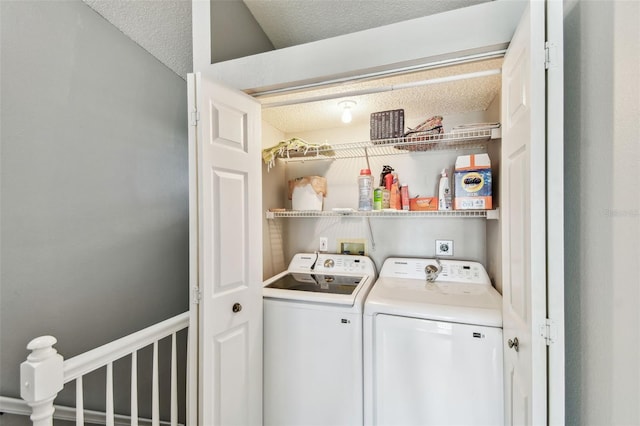 laundry room featuring laundry area, washer and clothes dryer, and a textured ceiling