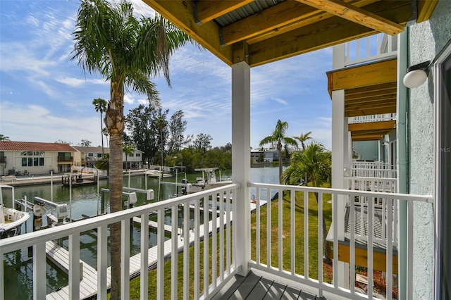 balcony featuring a dock, a water view, and boat lift