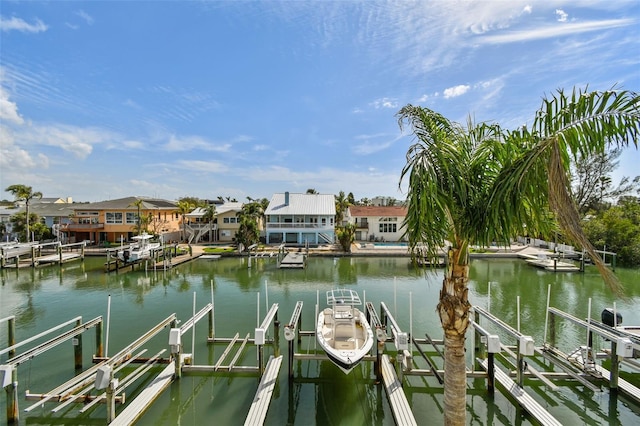 view of dock featuring a water view, boat lift, and a residential view