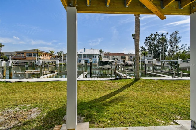 dock area featuring a lawn, a water view, and boat lift