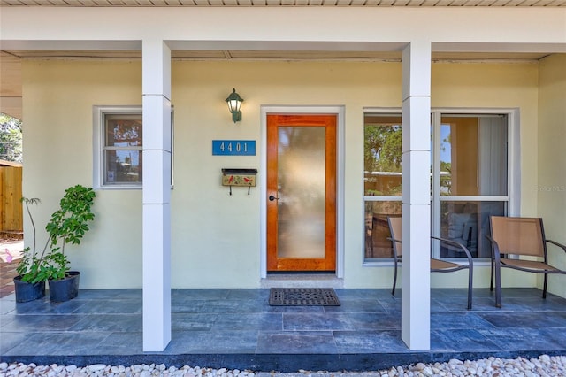 doorway to property featuring stucco siding