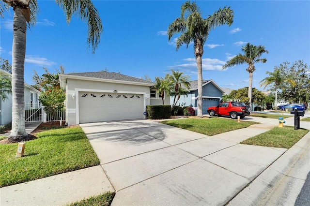 ranch-style house featuring a garage, a front lawn, concrete driveway, and stucco siding