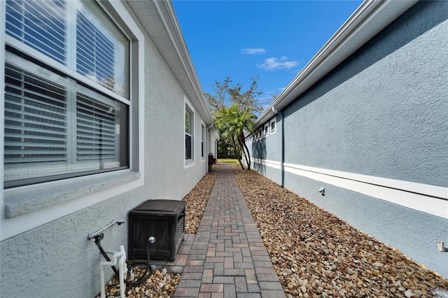 view of side of home with stucco siding