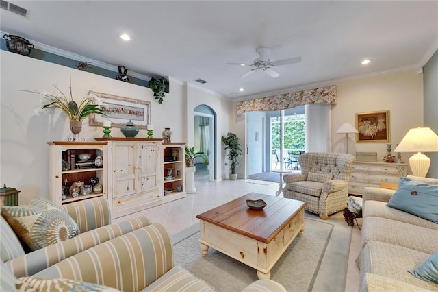 living area with recessed lighting, visible vents, arched walkways, and ornamental molding