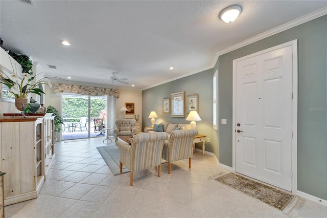 living room with light tile patterned floors, ornamental molding, a textured ceiling, and baseboards