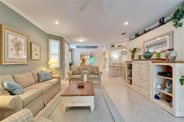 living room featuring crown molding, light tile patterned floors, recessed lighting, visible vents, and a ceiling fan