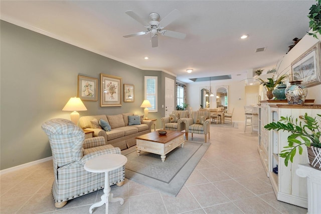 living room featuring crown molding, light tile patterned floors, visible vents, a ceiling fan, and baseboards