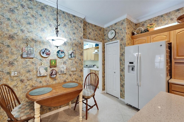 dining space featuring ornamental molding, washer and dryer, and light tile patterned floors