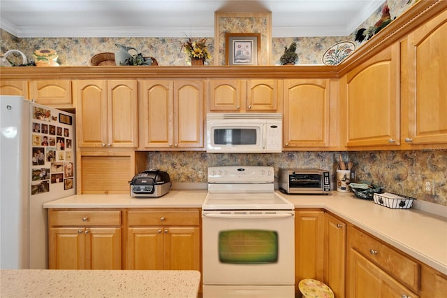 kitchen with a toaster, crown molding, light countertops, light brown cabinets, and white appliances