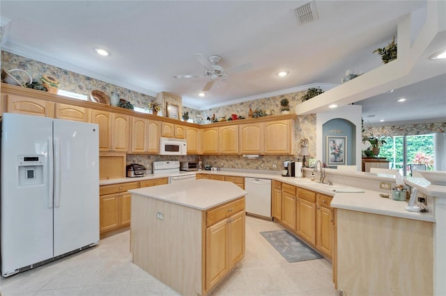 kitchen featuring light brown cabinets, a sink, white appliances, a peninsula, and wallpapered walls