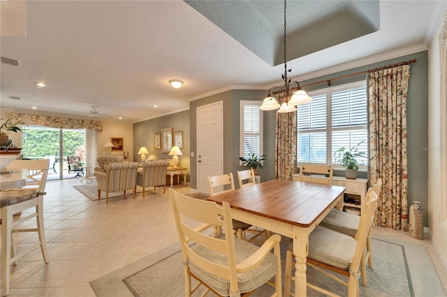 dining room featuring ornamental molding, ceiling fan with notable chandelier, visible vents, and light tile patterned flooring