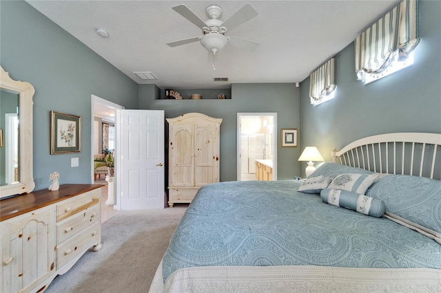 bedroom featuring light carpet, connected bathroom, visible vents, and a ceiling fan