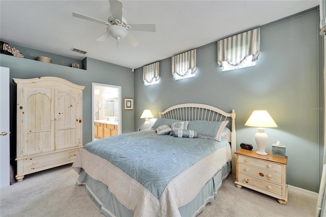 carpeted bedroom with visible vents, ceiling fan, and ensuite bath