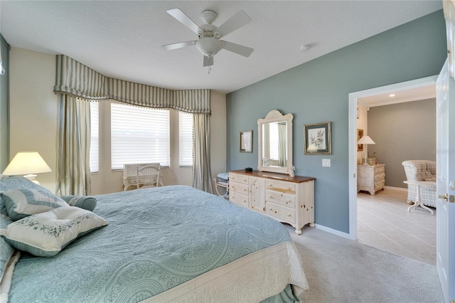 bedroom with carpet, tile patterned flooring, ceiling fan, and baseboards