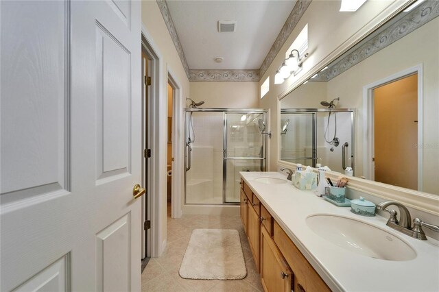 full bath with a stall shower, visible vents, and a sink