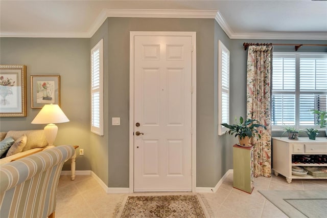 foyer entrance with light tile patterned floors, baseboards, and ornamental molding