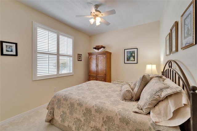 carpeted bedroom featuring baseboards and a ceiling fan