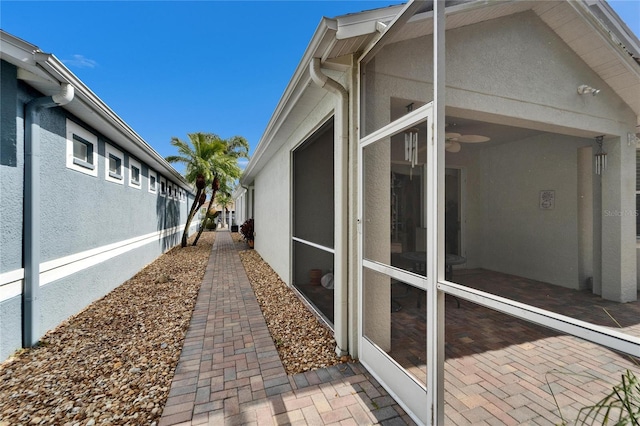 view of home's exterior with a lanai and stucco siding