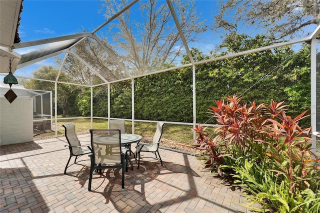 view of patio / terrace with a lanai and outdoor dining area