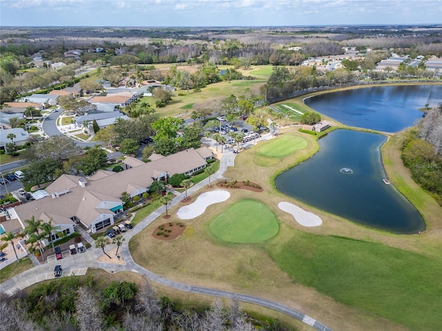 aerial view with golf course view and a water view