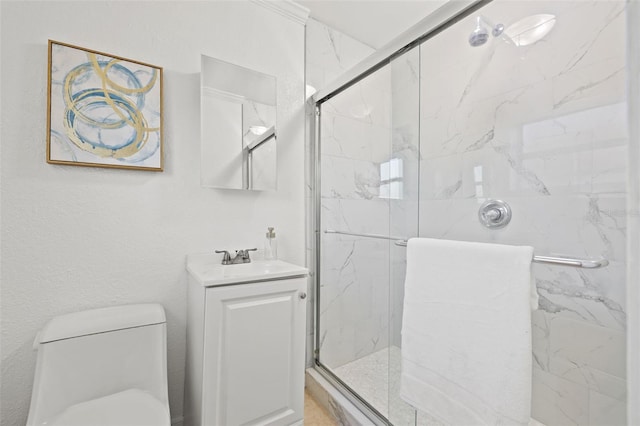 full bath with toilet, vanity, and a marble finish shower