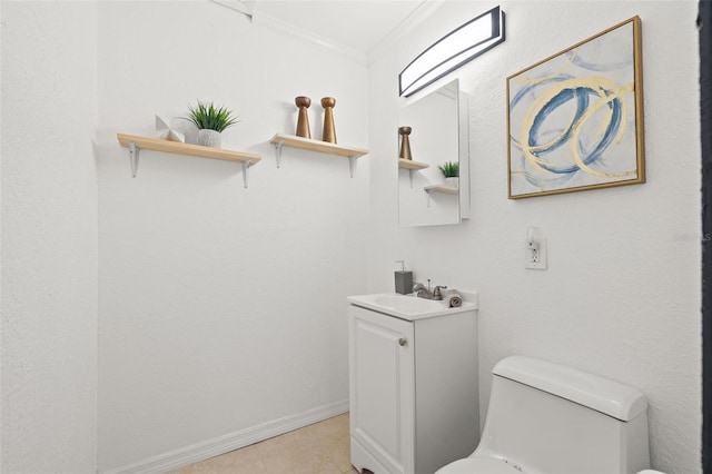 half bathroom featuring baseboards, vanity, toilet, and crown molding