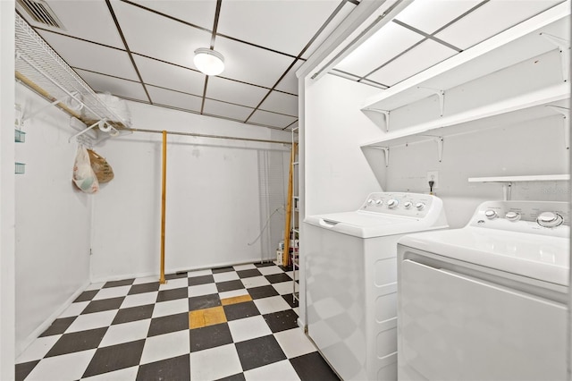 clothes washing area featuring laundry area, visible vents, washing machine and clothes dryer, and tile patterned floors