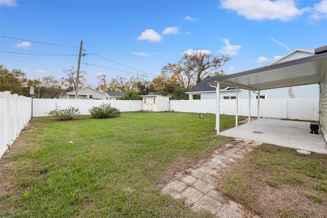 view of yard with a patio area, a fenced backyard, and an outdoor structure