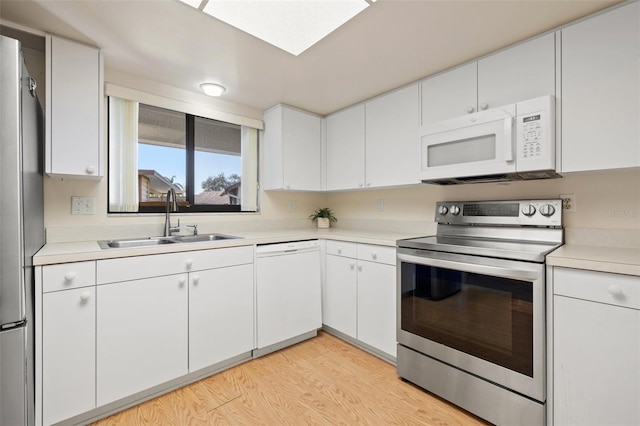 kitchen featuring light countertops, appliances with stainless steel finishes, and a sink