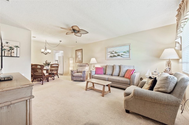 living area with light carpet, a textured ceiling, and ceiling fan with notable chandelier