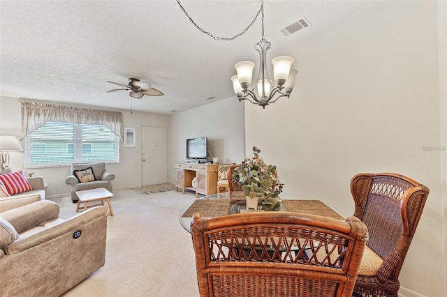 dining room featuring carpet, visible vents, a textured ceiling, baseboards, and ceiling fan with notable chandelier