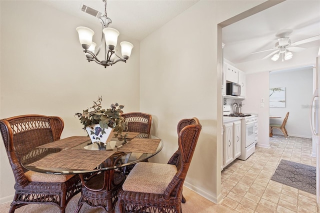 dining area featuring visible vents, baseboards, and ceiling fan with notable chandelier