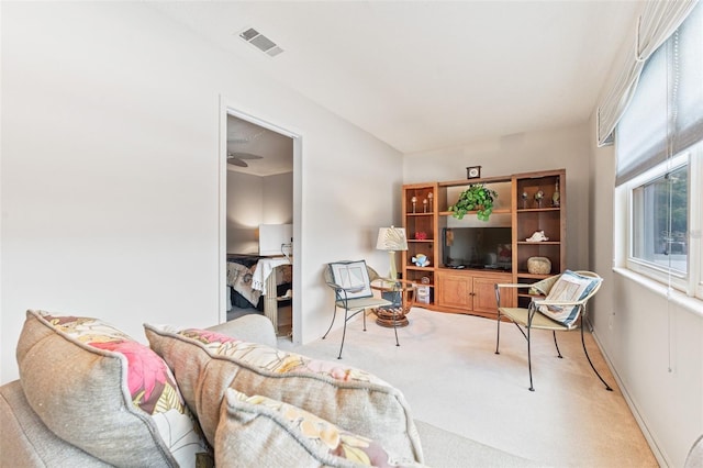 living area featuring visible vents and carpet flooring