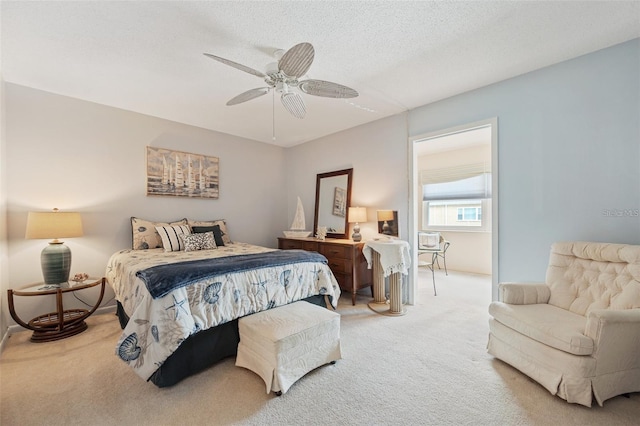 carpeted bedroom featuring ceiling fan, a textured ceiling, and baseboards