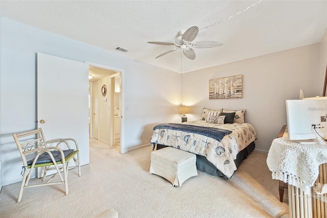 bedroom featuring carpet floors, visible vents, ceiling fan, a textured ceiling, and baseboards