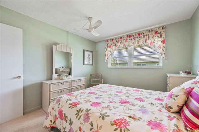 bedroom featuring a textured ceiling, carpet floors, and ceiling fan