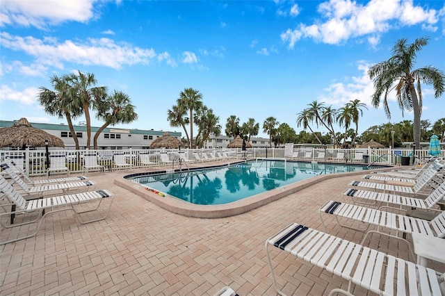 community pool featuring a patio area and fence