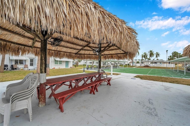 view of home's community featuring a yard and shuffleboard