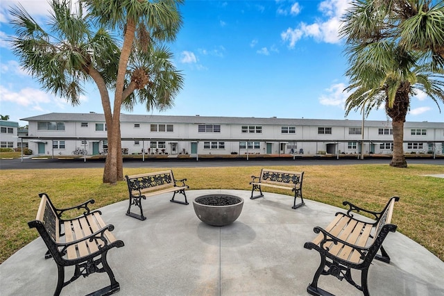 surrounding community featuring a patio area, a fire pit, and a yard